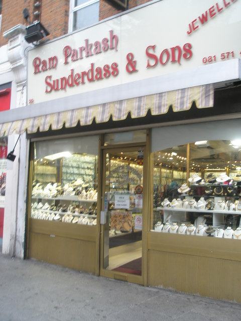 The window of a jeweller's shop on Southall Broadway, gold displayed on white trays