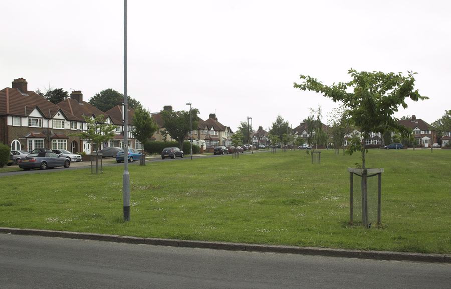 The green at Sutton Square, Heston, with inter-war semi-detached houses behind