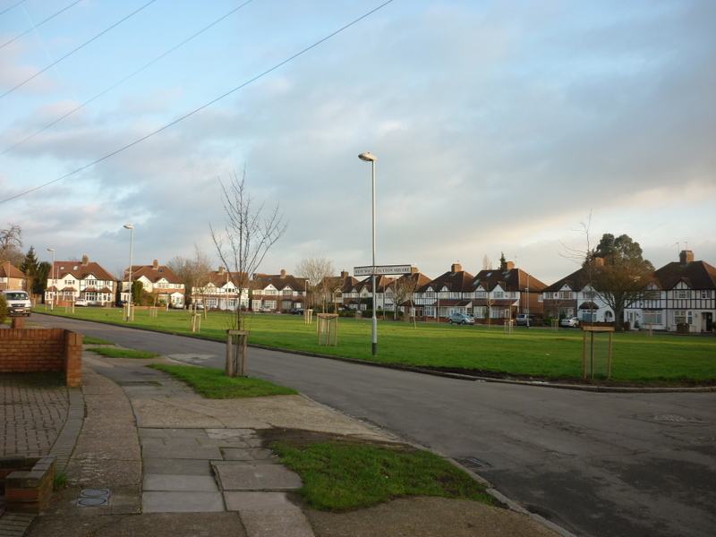 The road round Sutton Square, Heston, with the central green and mock-Tudor semis