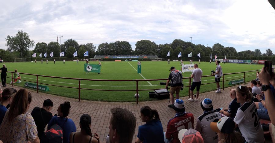 Spectators at the barrier watching a women's league match at the Sportpark Eimsbüttel