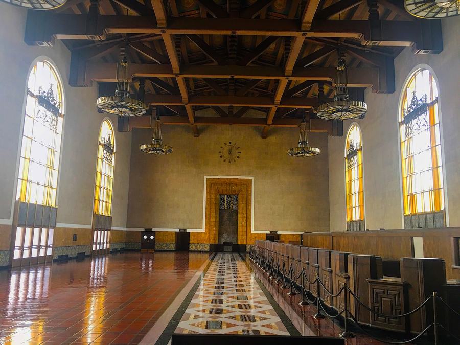 The long ticket concourse of Los Angeles Union Station with wooden counters and tall windows