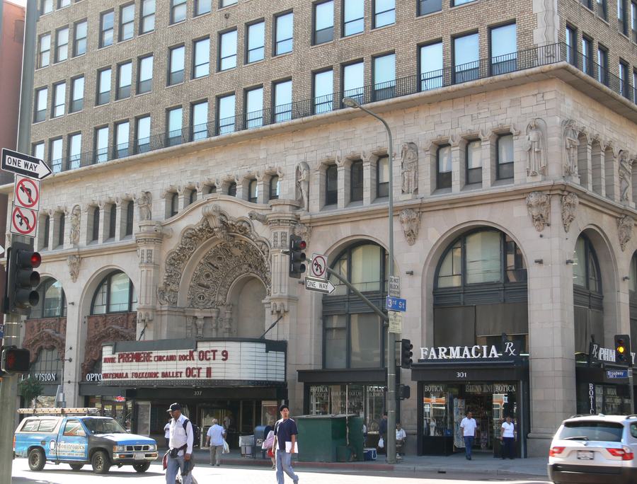 Ornate carved facade and lit marquee of the Million Dollar Theatre on South Broadway