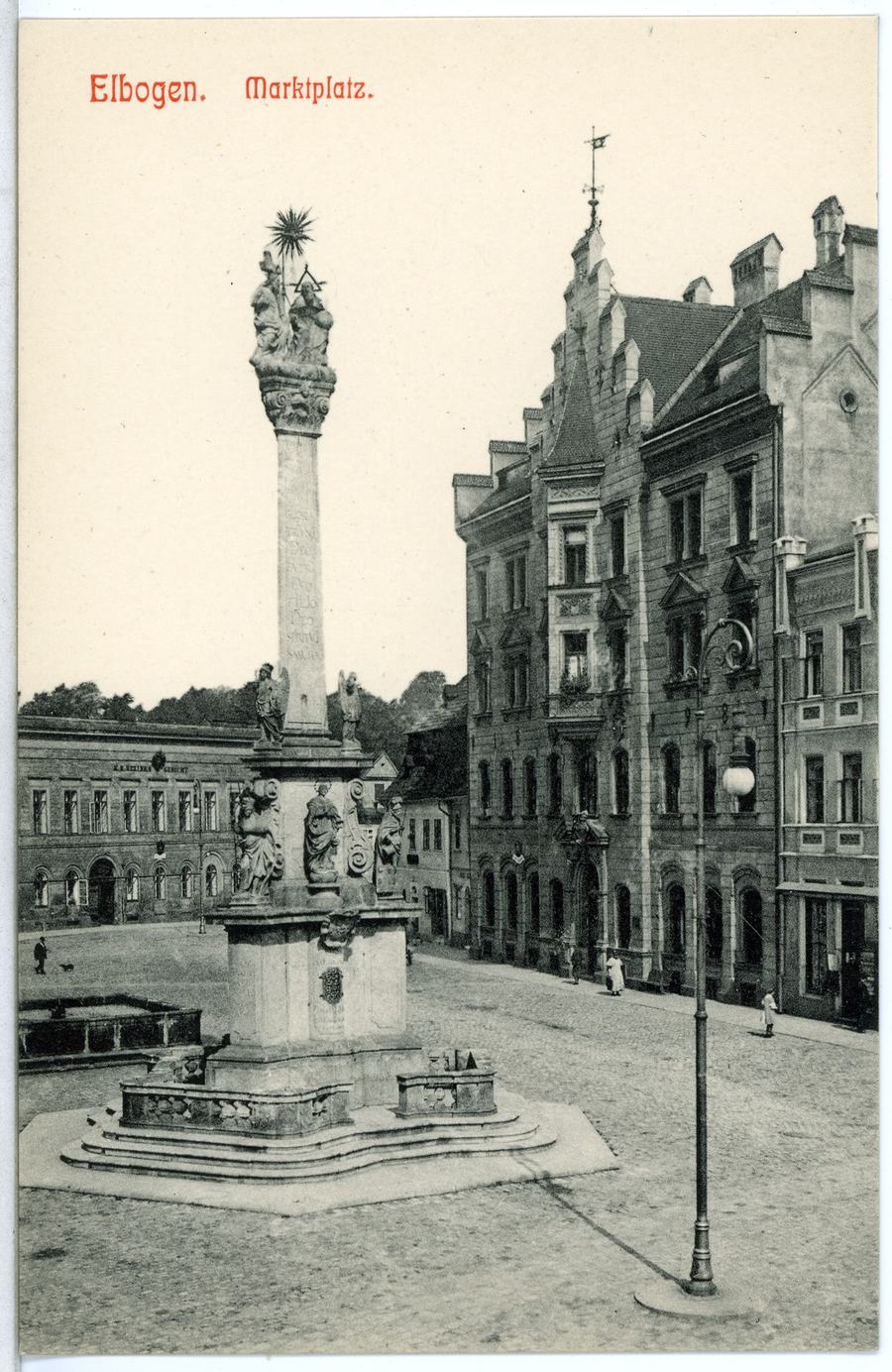 A black-and-white postcard captioned Elbogen Marktplatz, showing a baroque column on a stepped base in an empty cobbled square with tall houses and a street lamp.