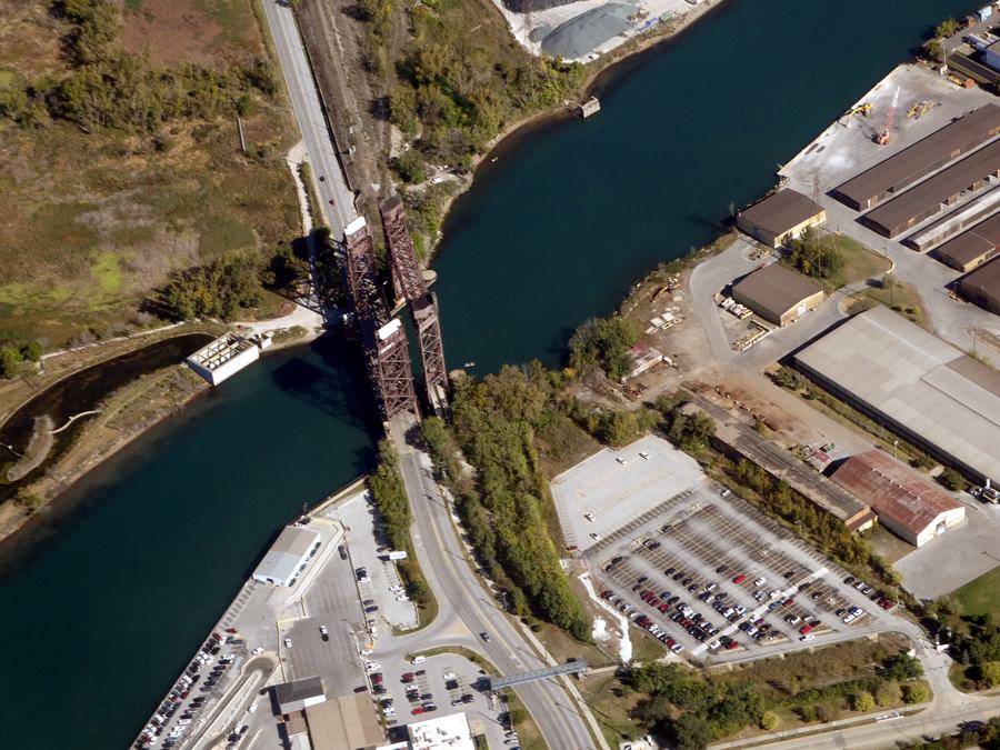 The Calumet River in Chicago from the air. The tall steel truss in the middle is the Chicago & Western Indiana railway lift bridge; the road crossing at the bottom of the frame is Torrence Avenue on the Henry Ford II Memorial Bridge.