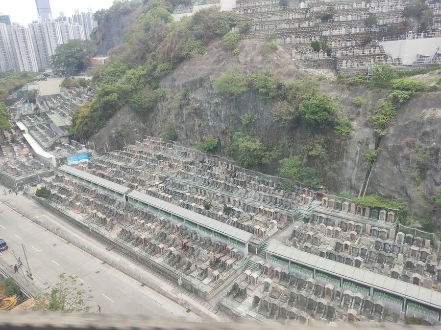 The terraced graves of Tsuen Wan Chinese Permanent Cemetery climbing the hillside above Kwai Chung, Hong Kong.
