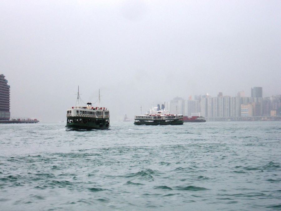 Two Star Ferries passing in Victoria Harbour on the crossing between Kowloon and Hong Kong Island.