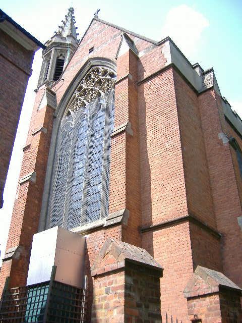 Red-brick Gothic chapel of the former Convent of the Holy Name at Malvern Link, its east window boarded and meshed