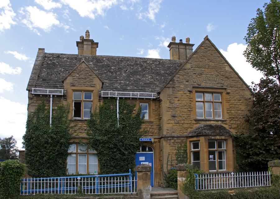 Victorian Cotswold-stone police station with blue railings at Moreton-in-Marsh
