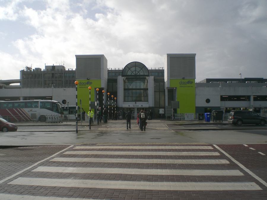 The entrance frontage of Dublin Airport Terminal 1, photographed in 2008, with buses at the kerb and a pedestrian crossing in the foreground.