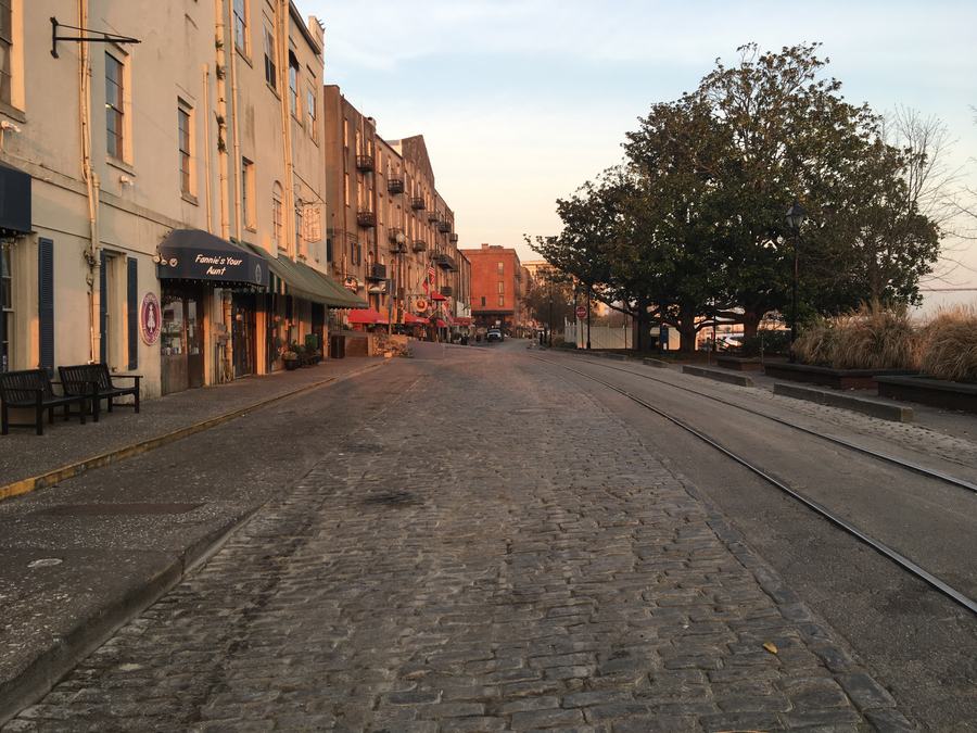 Cobbled River Street along the Savannah waterfront with brick warehouses