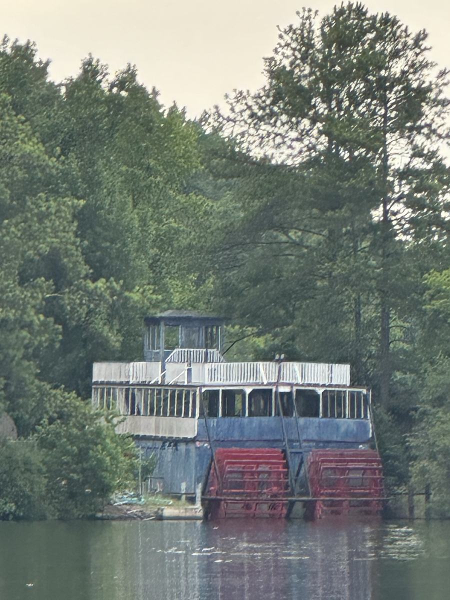 Decommissioned paddle steamer moored among trees at Stone Mountain Lake, 2024
