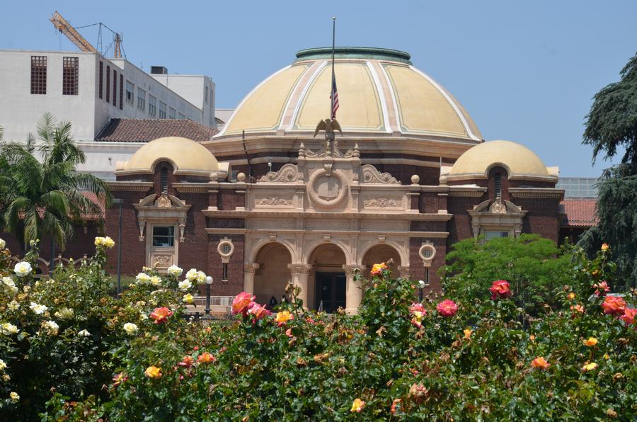 Beaux-arts museum facade with a dome, seen across lawns
