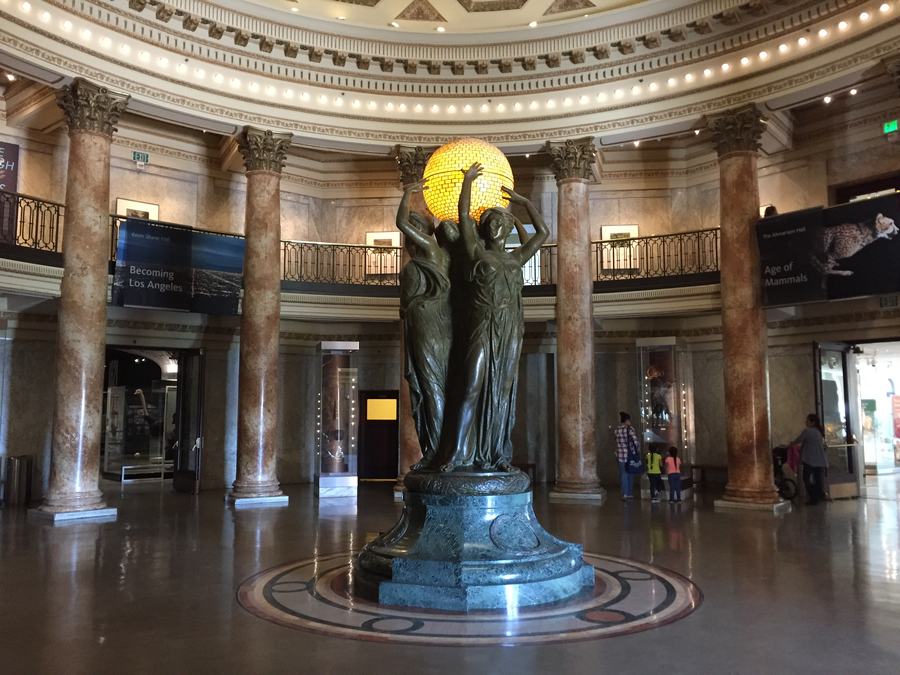 Domed marble rotunda with columns and a bronze sculpture group in the middle