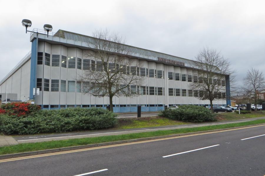 A long low industrial hangar building at Hatfield with a fitness club sign on the front