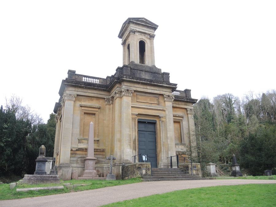 Classical stone chapel with a square bell tower among trees and grass, Arnos Vale Cemetery, Bristol