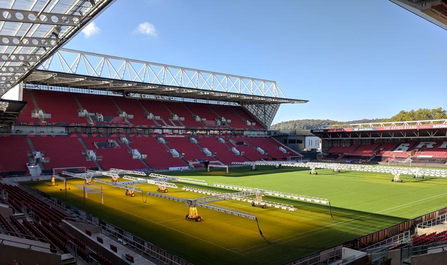 Ashton Gate stadium from the stands, facing the red seats of the Lansdown Stand across the pitch