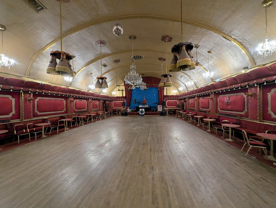 The empty Rivoli Ballroom: a sprung wooden floor under a curved gold ceiling, red padded walls, chandeliers and lanterns