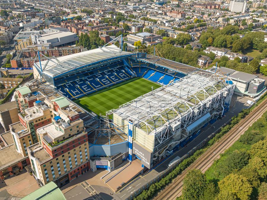 An aerial view of Stamford Bridge stadium, with CHELSEA spelled out in the blue seats, among west London streets