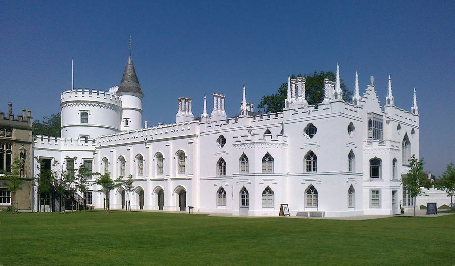 Strawberry Hill House, a white Gothic Revival villa with battlements, pinnacles and a round tower, behind a lawn